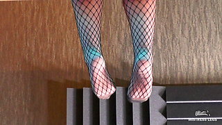 Mistress sexy feet teasing in fishnets and opaque pantyhose