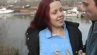 Redhead student sucks on the banks of the river for all to see
