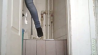 Hot young brunette girl in jeans shows her pussy in the toilet