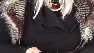 Blonde lady smokes an electronic cigarette