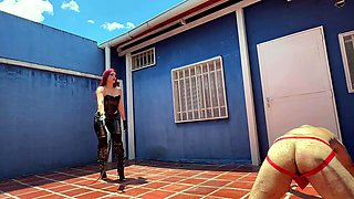 Leather mistress whips her slave with her bullwhip