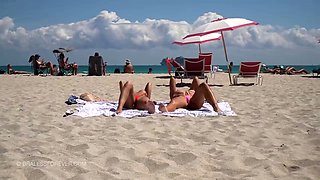 Sensuous babes in sexy bikinis sunbathing on the beach