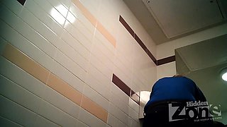 Blonde girl pissing in the toilet on the spy camera