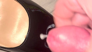 Cumming on black patent heels