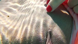 Whorish red head Micha Gantelkina gets naked under the water and performs her pussy closeup