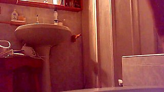 Young girl masturbates on the toilet with a big rubber dildo