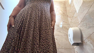 A horny mature MILF is very aroused and is rubbing her pussy in the public restroom at the office.