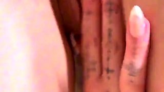Naked busty vixen oils herself up and masturbates on the bed
