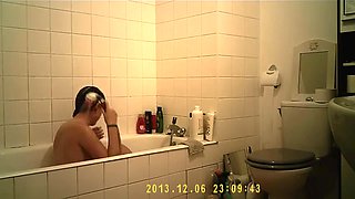 Brunette cutie enjoys a hot shower in the bathroom