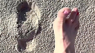 Comparing Size 16 Feet to Sand Prints at the Beach