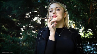 Hot Blonde Babe Smoking Two Black Cigarettes in Nature