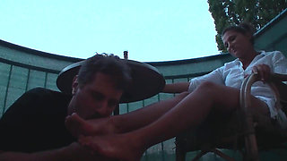 Sexy femdom smoking a cigarette while getting feet licked and toes sucked