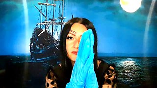 Dominatrix Nika with a glove fetish puts on medical gloves and destroys them with her long tools