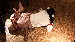 A Cute Little Dressed in a Jk Uniform Was Walking Around Barefoot on the Ground.