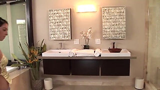 Brunette teen gives handjob in soap and oil