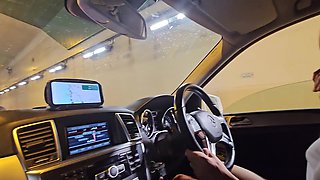 While our car is immobilized in freeway congestion, she grasps my penis in her hand.