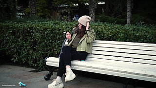 Young Brunette Is Taking an Unhurried Stroll with Allwhite 120mm Cigarette