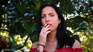 Sultry Brunette in Red Dress Smoking Rolled Cigarette