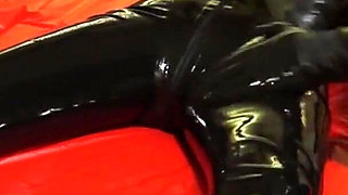 Oil body in latex catsuit