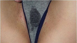 Wet panties betray her arousal as she touches herself