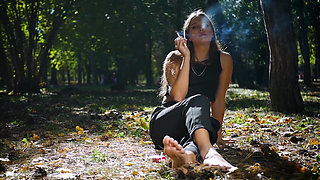 Seductive Russian Beauty Smoking Cigarette in Studio